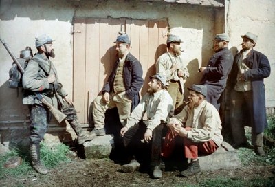 Seven French Soldiers in Front of a Building, One Carries His Gun and Equipment, France, c.1914-18 by French Photographer